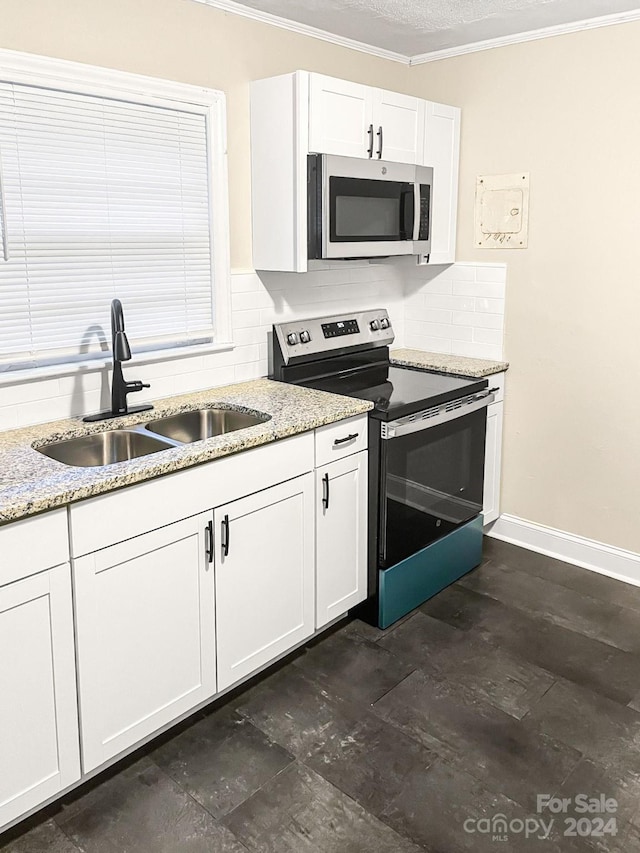 kitchen with white cabinets, sink, tasteful backsplash, stainless steel appliances, and light stone countertops