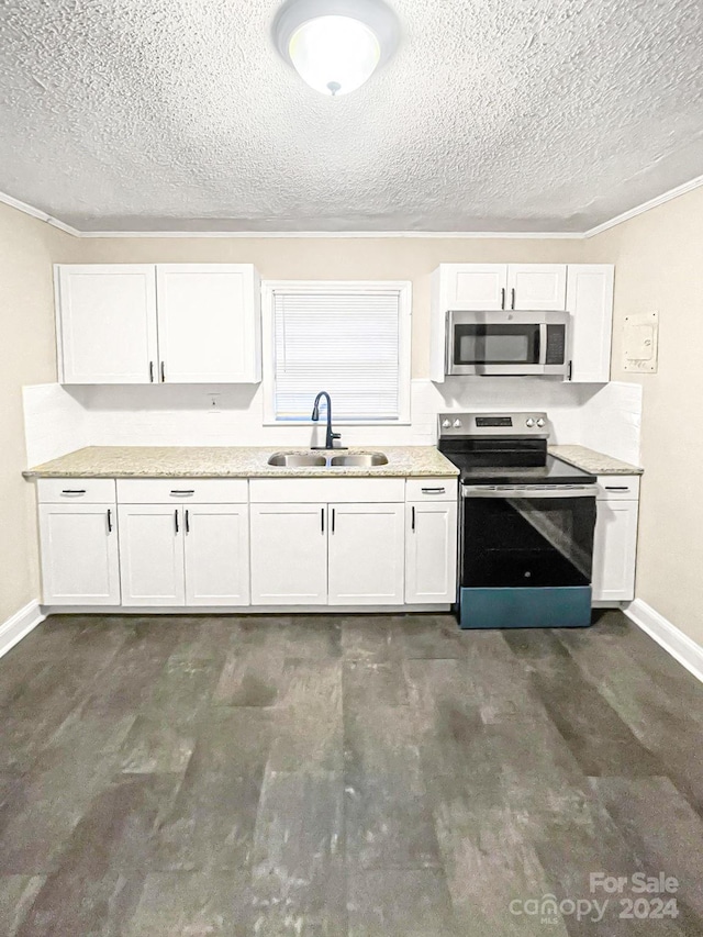 kitchen with a textured ceiling, sink, stainless steel appliances, and white cabinets