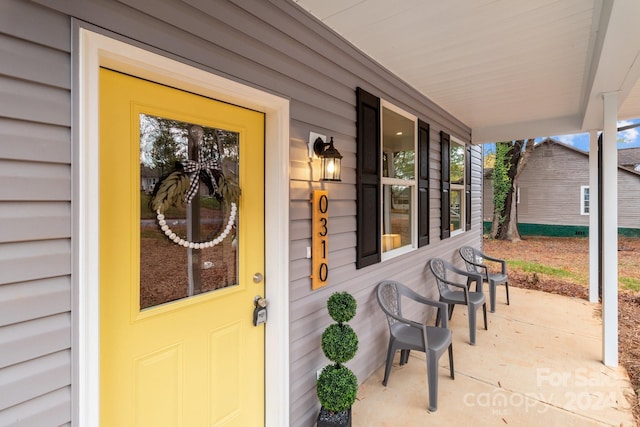 doorway to property featuring covered porch