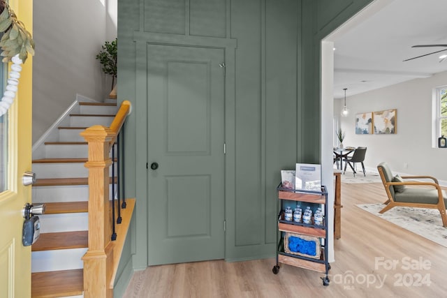 stairs featuring hardwood / wood-style floors