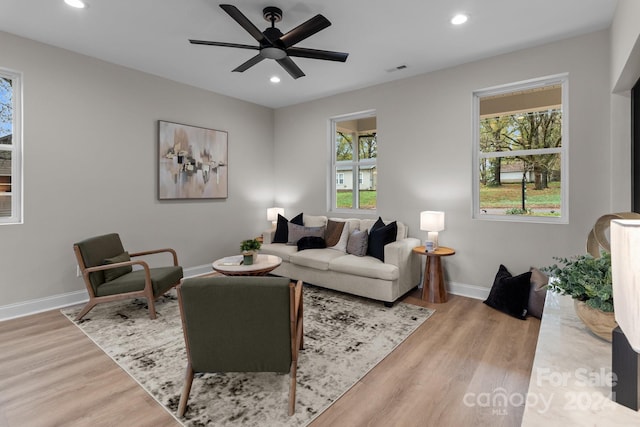 living room with wood-type flooring, a healthy amount of sunlight, and ceiling fan