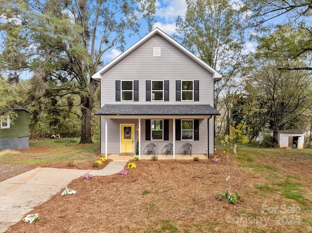 front of property featuring a storage shed and a porch