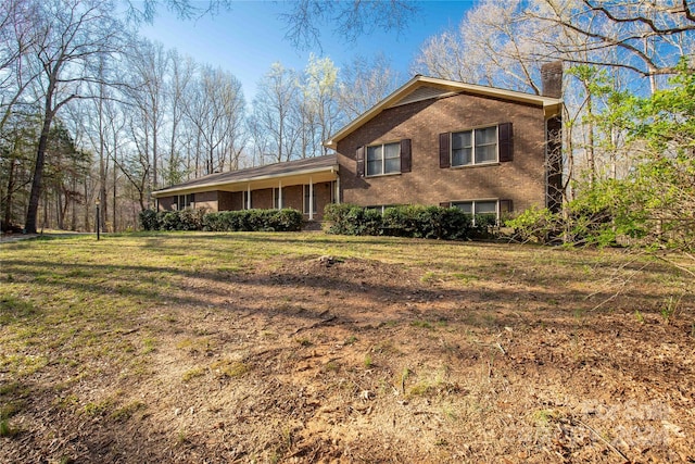 split level home featuring a front lawn