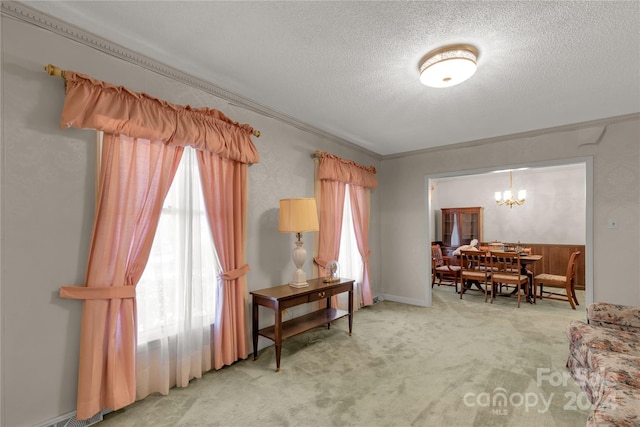 interior space featuring light colored carpet, a notable chandelier, a textured ceiling, and crown molding