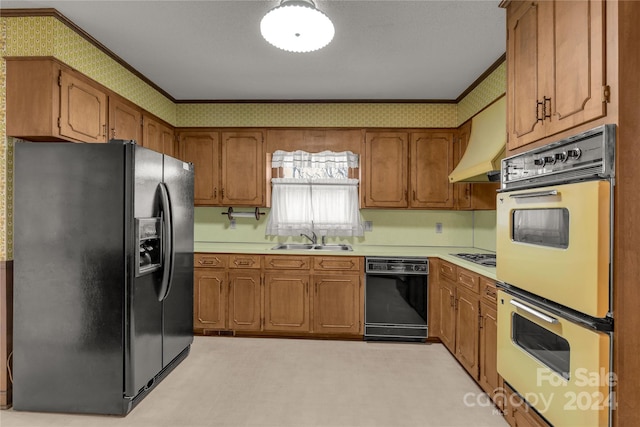 kitchen featuring premium range hood, ornamental molding, sink, and black appliances