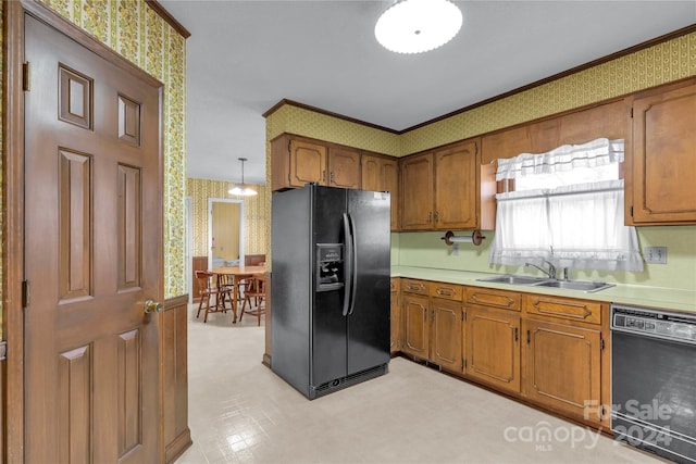 kitchen with crown molding, light tile floors, black appliances, pendant lighting, and sink