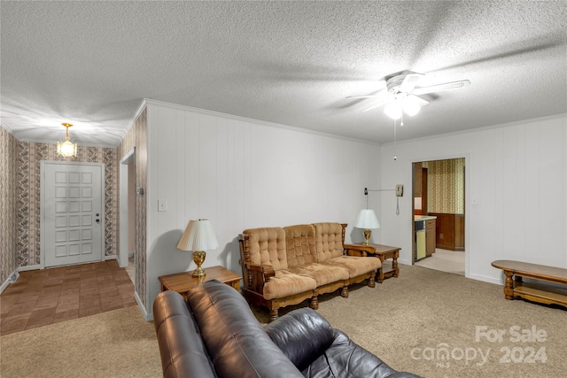 carpeted living room with ceiling fan and a textured ceiling