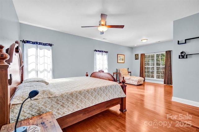 bedroom with wood-type flooring and ceiling fan