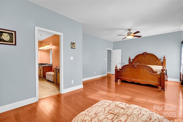 bedroom with ceiling fan, ensuite bath, and light hardwood / wood-style flooring