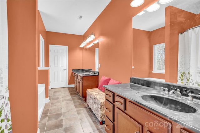 bathroom with vanity, tile patterned flooring, and shower with separate bathtub