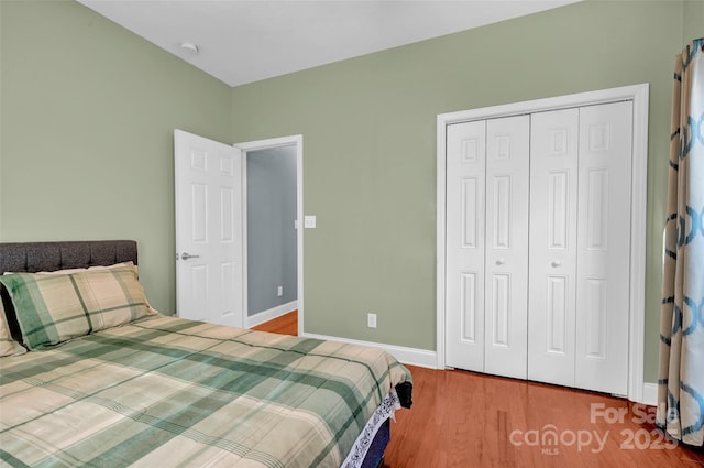 bedroom featuring hardwood / wood-style floors and a closet