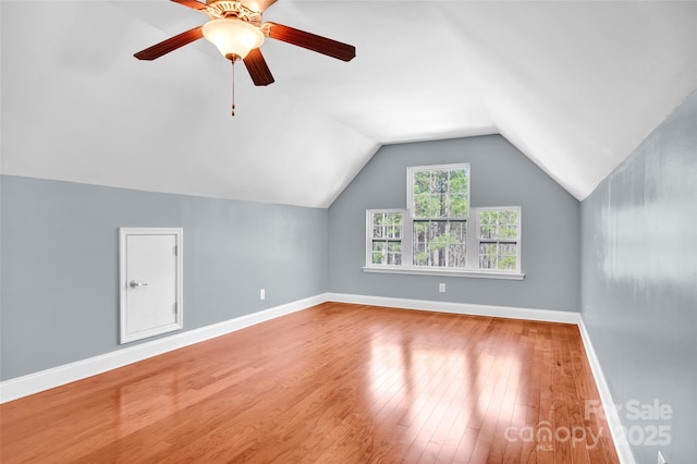 additional living space with ceiling fan, lofted ceiling, and wood-type flooring