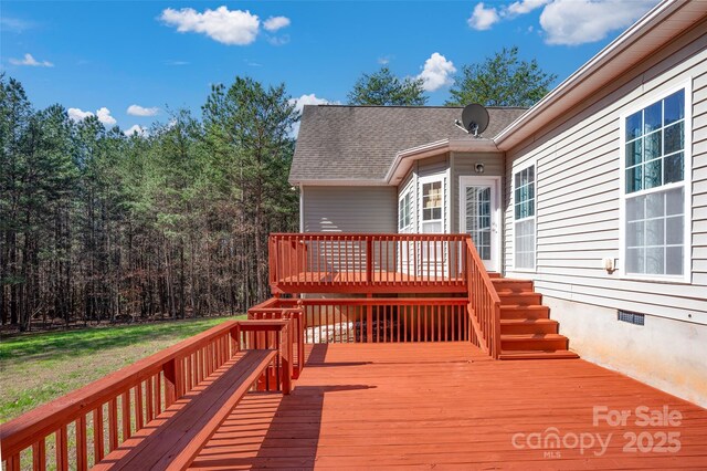 wooden deck with a lawn