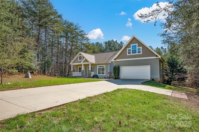 view of front of home featuring a garage, a front lawn, and covered porch