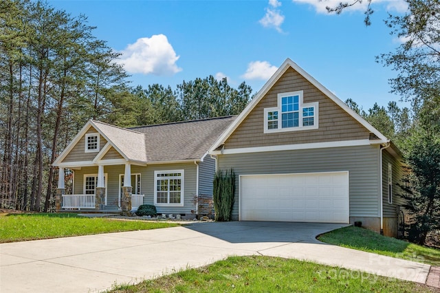 craftsman-style house featuring a porch, a garage, and a front lawn