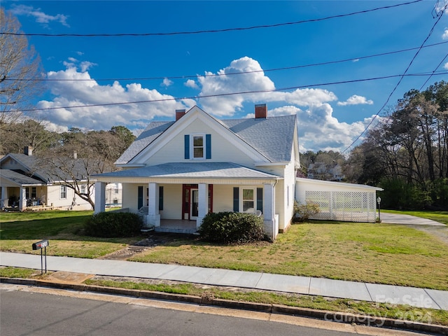 view of front of property with a front yard and covered porch