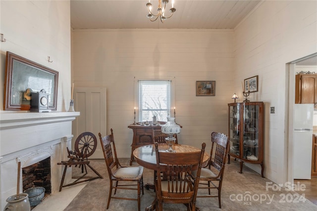 dining room with a chandelier and light colored carpet