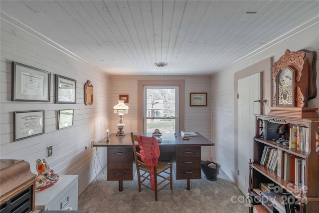 office featuring light colored carpet, wood walls, wooden ceiling, and ornamental molding