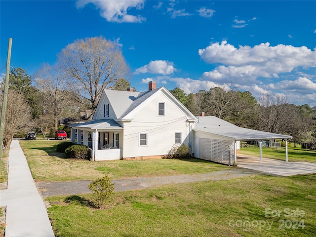 view of property exterior with a yard and a carport