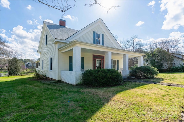 view of front of property with a porch and a front lawn