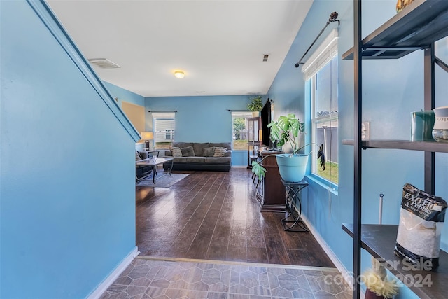 hallway with dark hardwood / wood-style flooring