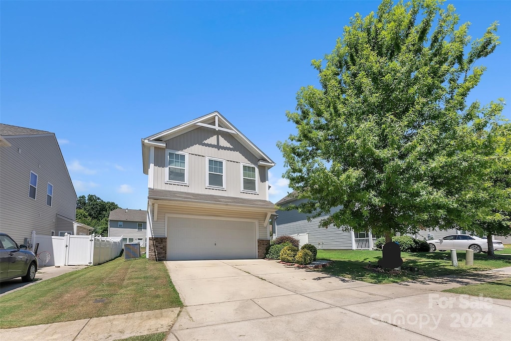 craftsman house with a front yard and a garage