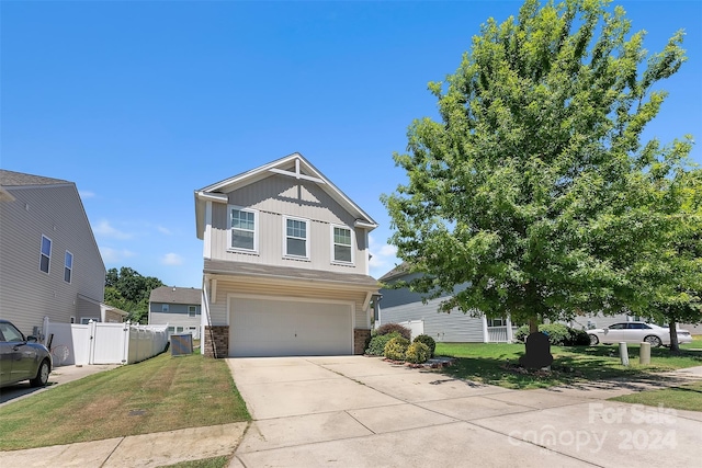 craftsman house with a front yard and a garage