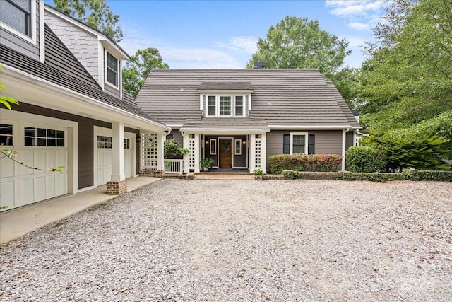 view of front facade featuring covered porch and a garage