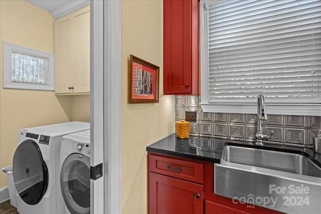 laundry area with independent washer and dryer, sink, and cabinets