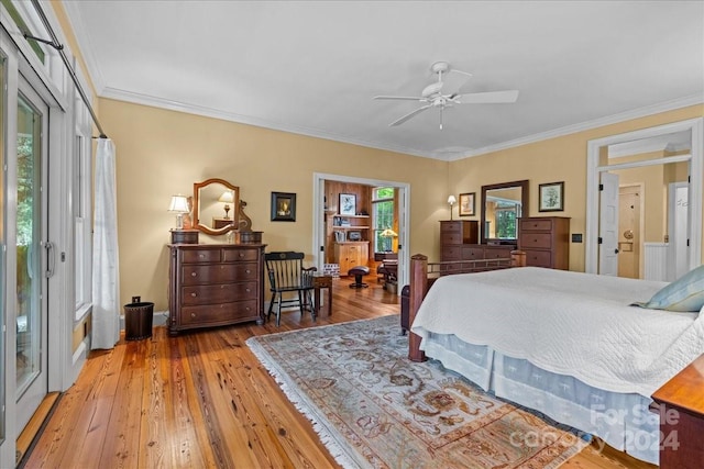 bedroom featuring light hardwood / wood-style floors, ceiling fan, and ornamental molding