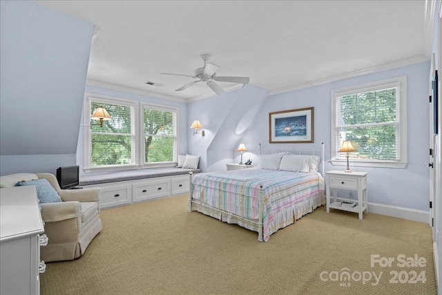 carpeted bedroom featuring ceiling fan, ornamental molding, and multiple windows