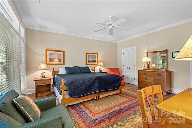 bedroom featuring ornamental molding, a closet, ceiling fan, and hardwood / wood-style flooring