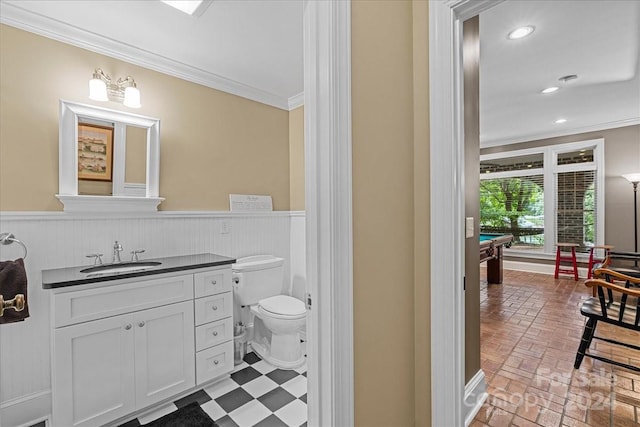 bathroom with crown molding, toilet, vanity, and billiards