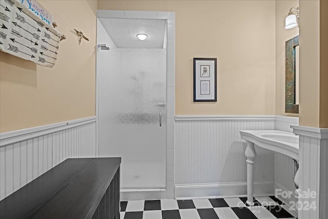 bathroom with walk in shower and tile floors