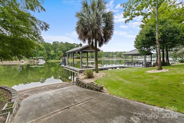 view of dock featuring a gazebo, a water view, and a lawn