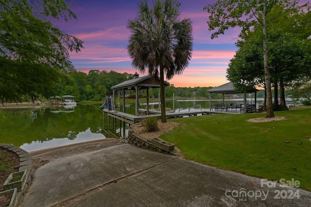 dock area featuring a gazebo, a lawn, and a water view