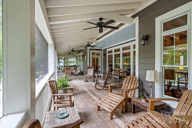 sunroom / solarium featuring ceiling fan and lofted ceiling with beams