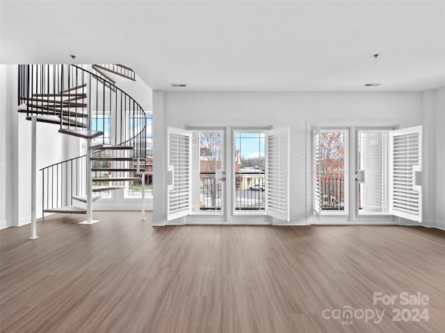 unfurnished living room with hardwood / wood-style floors