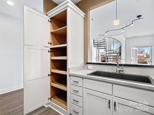 kitchen with light hardwood / wood-style flooring, hanging light fixtures, rail lighting, and white cabinetry