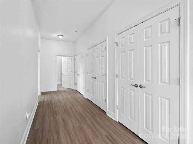 corridor featuring dark hardwood / wood-style floors