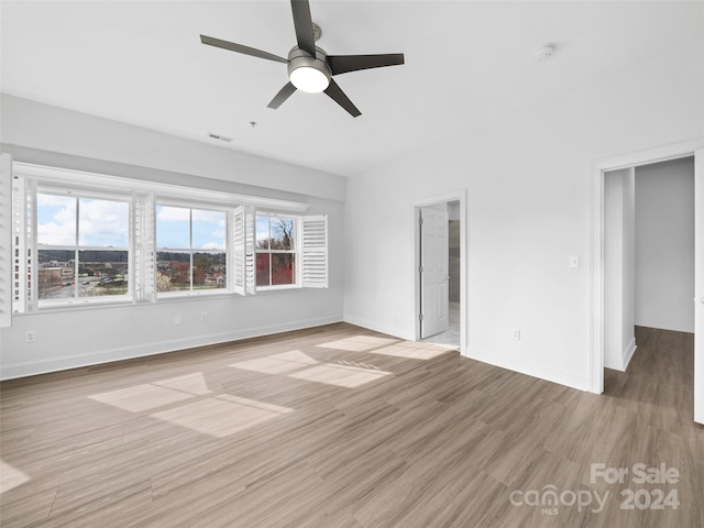 spare room featuring ceiling fan and light hardwood / wood-style flooring