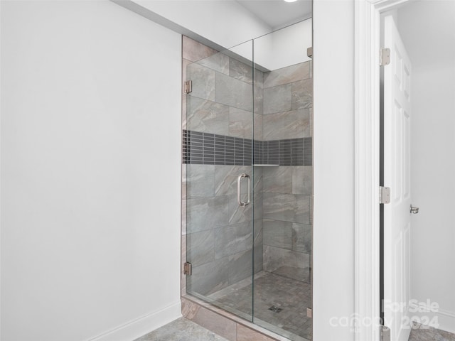 bathroom featuring a shower with door