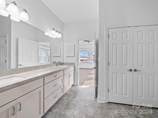 bathroom with ceiling fan, double sink vanity, and tile flooring