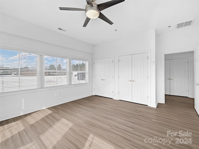 spare room with dark hardwood / wood-style floors and ceiling fan