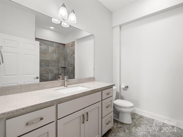 bathroom with tile flooring, toilet, and vanity