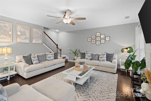 living room with dark hardwood / wood-style flooring and ceiling fan