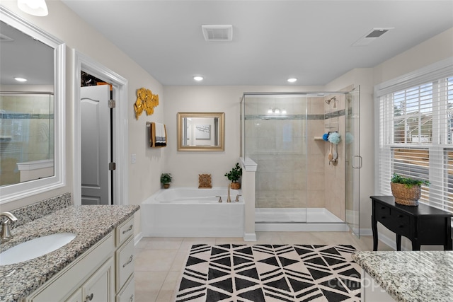 bathroom featuring tile patterned flooring, vanity, and shower with separate bathtub