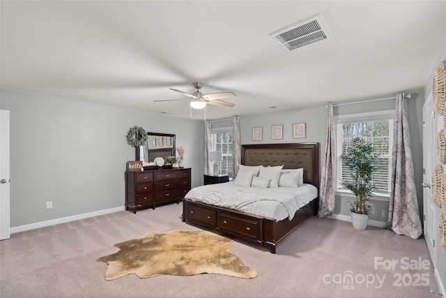 carpeted bedroom featuring multiple windows and ceiling fan