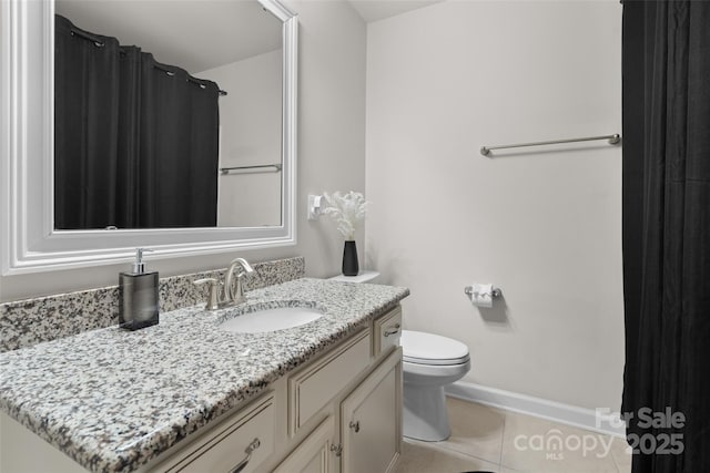 bathroom with tile patterned flooring, vanity, and toilet