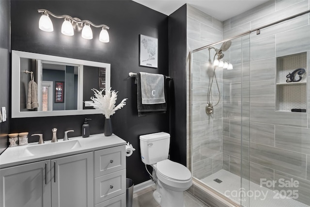 bathroom featuring vanity, toilet, and an enclosed shower